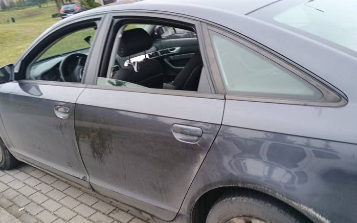 Samochód z otwartymi drzwiami, widać brud i zniszczenia.