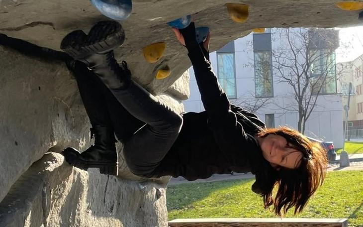 Kobieta wspinająca się na ściance wspinaczkowej.