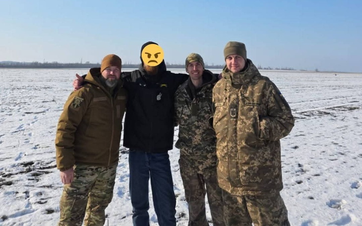 Czterech mężczyzn w zimowym krajobrazie, w mundurach.