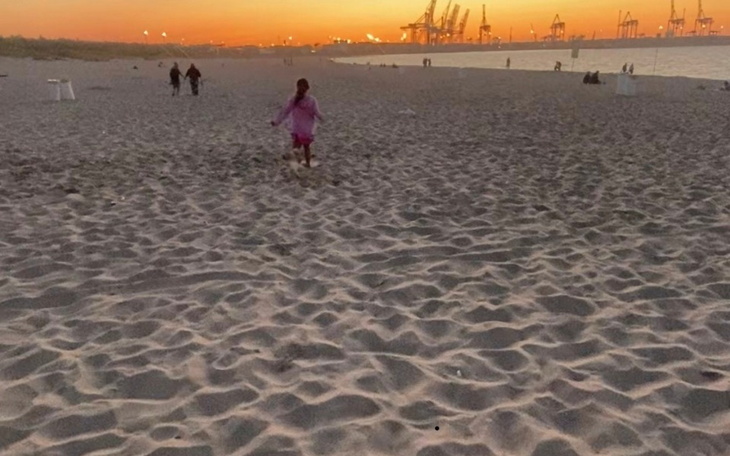 Dziecko biegające po plaży podczas zachodu słońca.