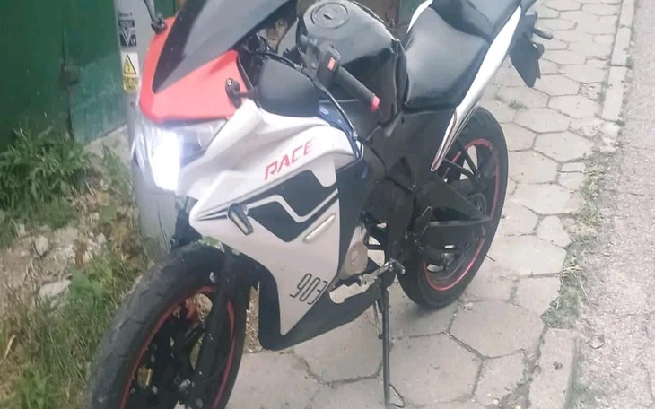 Motocykl sportowy zaparkowany na chodniku.