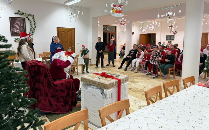 Grupa ludzi w czapkach Mikołaja, uczestniczących w świątecznym wydarzeniu.