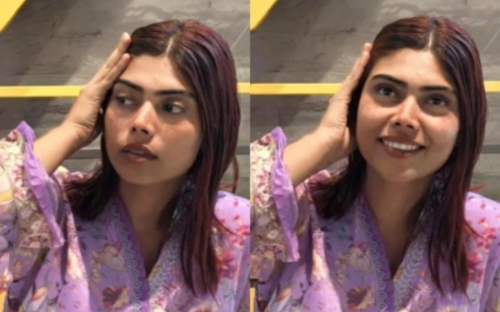 Kobieta w fioletowej bluzce, z wyrazem zdziwienia na twarzy.