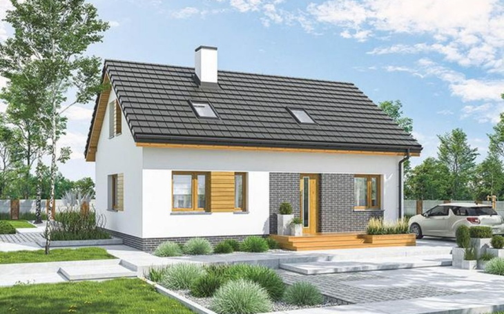 Nowoczesny dom z ogrodem i samochodem przed wejściem.