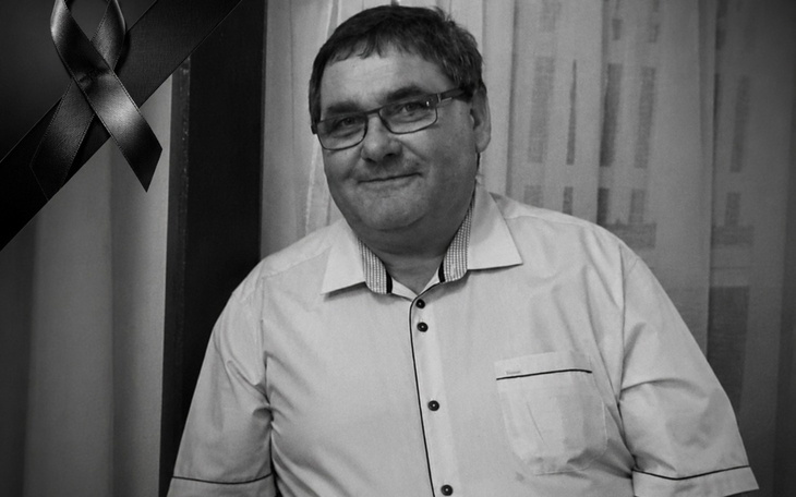 Człowiek w białej koszuli, z symbolem żalu w rogu zdjęcia.