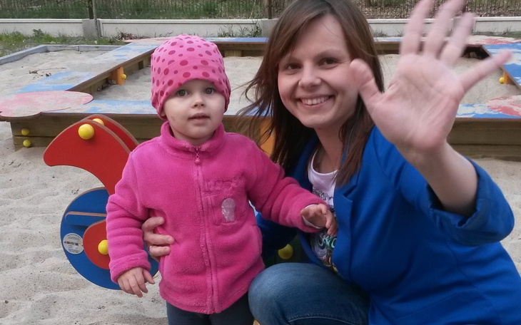 Mama z dzieckiem na placu zabaw, uśmiechnięte twarze.