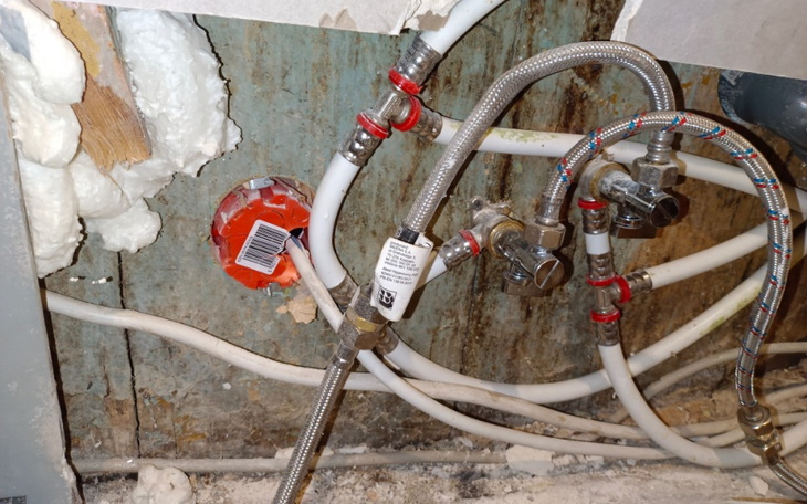 Rury i instalacje wodne w ścianie, widok z bliska.