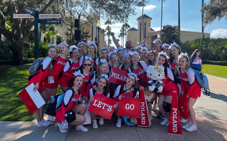 Grupa cheerleaderek w strojach z hasłami dla Polski.
