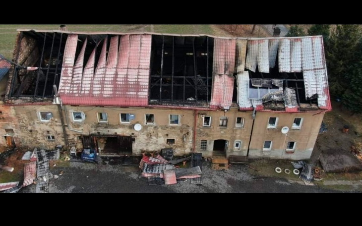 Zniszczony budynek z uszkodzonym dachem, widok z lotu ptaka.