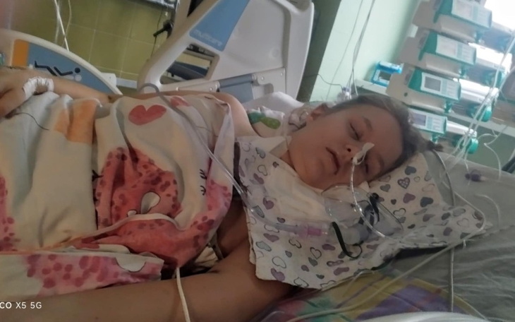 Kobieta w szpitalu, podłączona do aparatury medycznej.