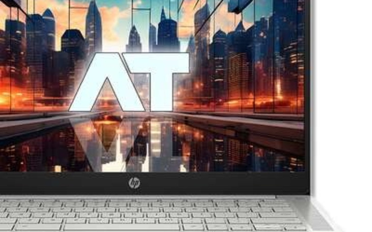 Laptop z futurystycznym tłem na ekranie.