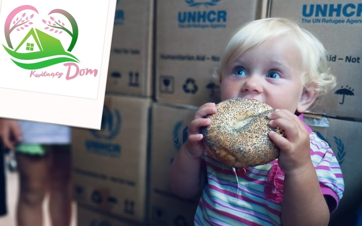 Mała dziewczynka trzymająca bajgla, w tle kartony.