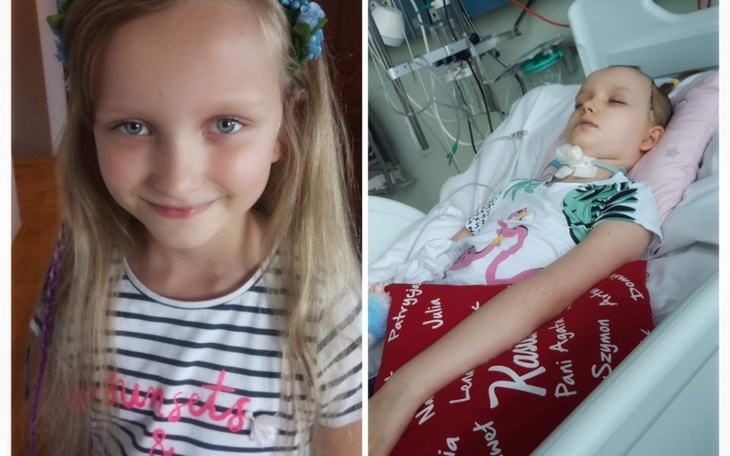 Dziewczynka uśmiechająca się obok chorej dziewczynki w szpitalu.
