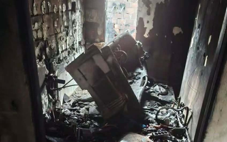 Zniszczony pokój po pożarze, z ruinami sprzętu.