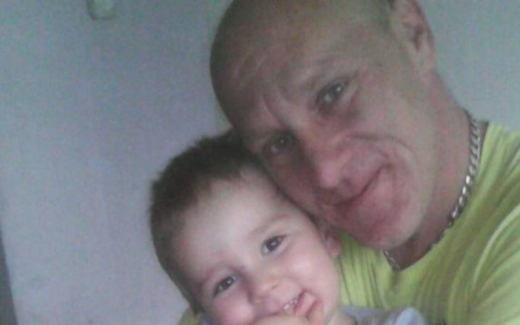 Mężczyzna z dzieckiem, uśmiechnięci.