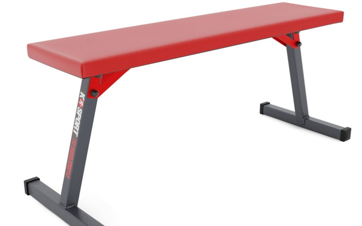 Ławka do ćwiczeń w kolorze czerwonym, idealna do treningu siłowego.
