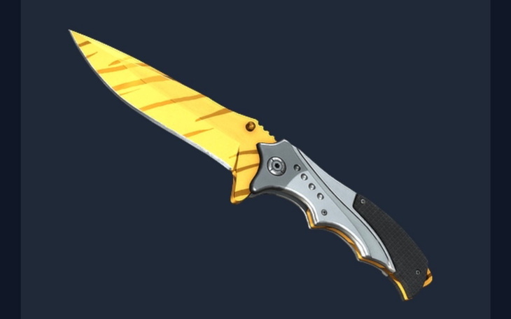 Złoty nóż składany na ciemnym tle.