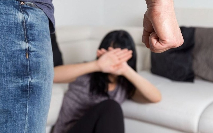 Scena przemocy domowej, kobieta chroni się przed mężczyzną.