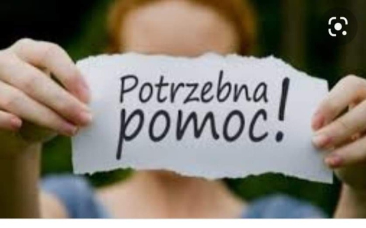 Osoba trzymająca kartkę z napisem 'Potrzebna pomoc!'