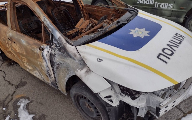 Zniszczony samochód policyjny, widoczny z przodu.