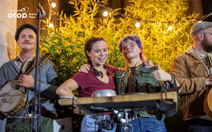 Muzycy grający na instrumentach, bawiący się na scenie.