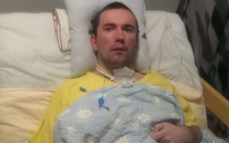 Mężczyzna w szpitalu, z widocznymi oznakami zmęczenia.