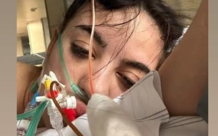 Kobieta w szpitalu, z rurkami i tlenem, leżąca na łóżku.