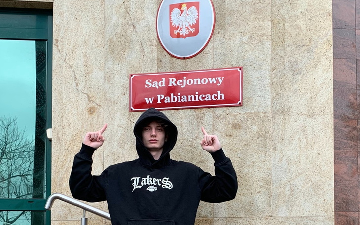 Mężczyzna wskazujący na Sąd Rejonowy w Pabianicach.