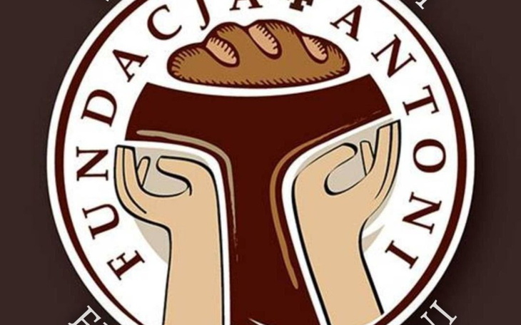 Logo fundacji z chlebem w dłoniach.