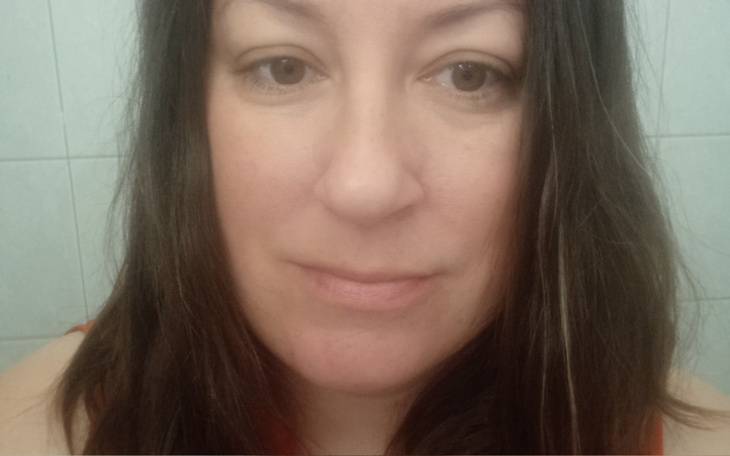 Portret kobiety z długimi włosami w łazience.