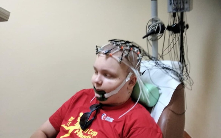 Chłopak z elektrodami na głowie, w trakcie badania.
