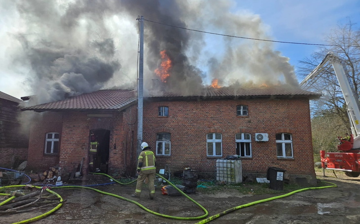 Pożar w budynku, strażacy walczą z ogniem.