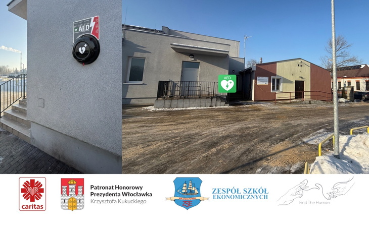 Budynek z defibrylatorem AED na ścianie.