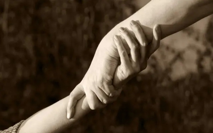 Dwie dłonie trzymające się nawzajem, symbolizujące wsparcie i bliskość.