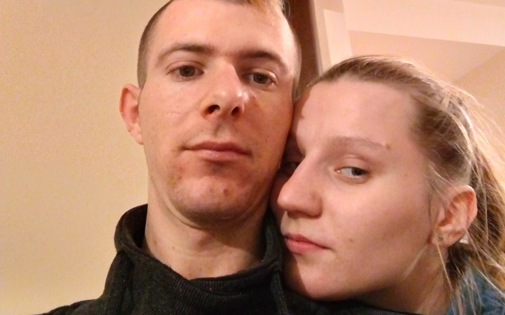 Para przytulająca się, uśmiechnięta w domowym otoczeniu.