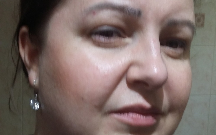 Kobieta z bliska, naturalny makijaż i biżuteria.