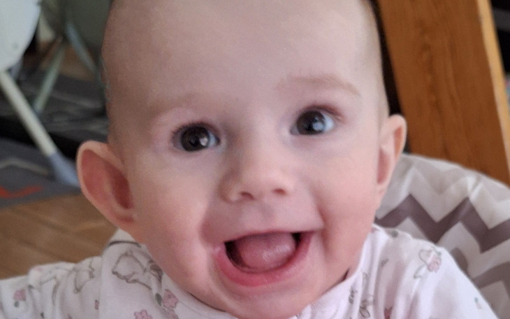 Uśmiechnięte niemowlę, pełne radości i energii.