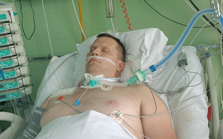 Mężczyzna leżący w szpitalu, podłączony do aparatury medycznej.