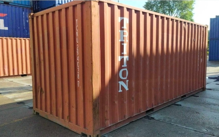 Pomarańczowy kontener transportowy na placu.