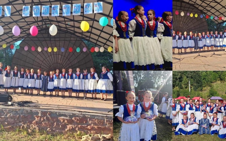 Grupa dzieci w tradycyjnych strojach, występujących na scenie.