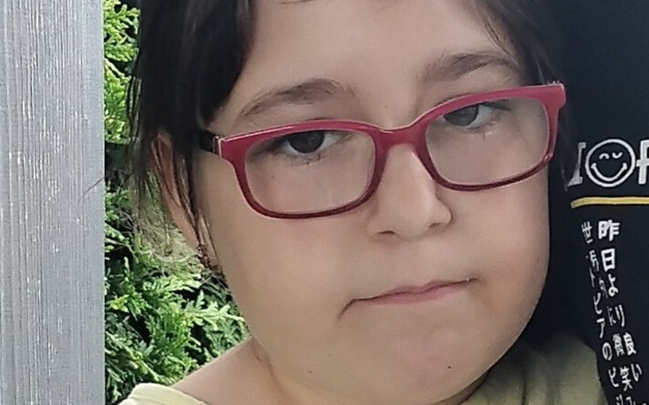 Dziewczynka w okularach z poważnym wyrazem twarzy.