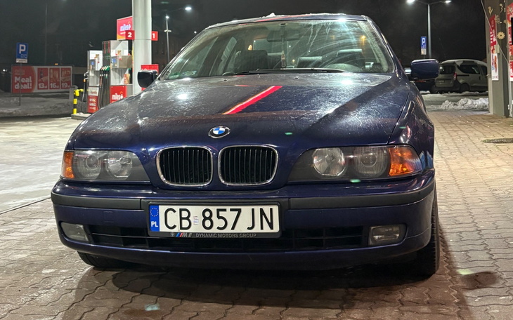 Samochód marki BMW zaparkowany na stacji benzynowej.