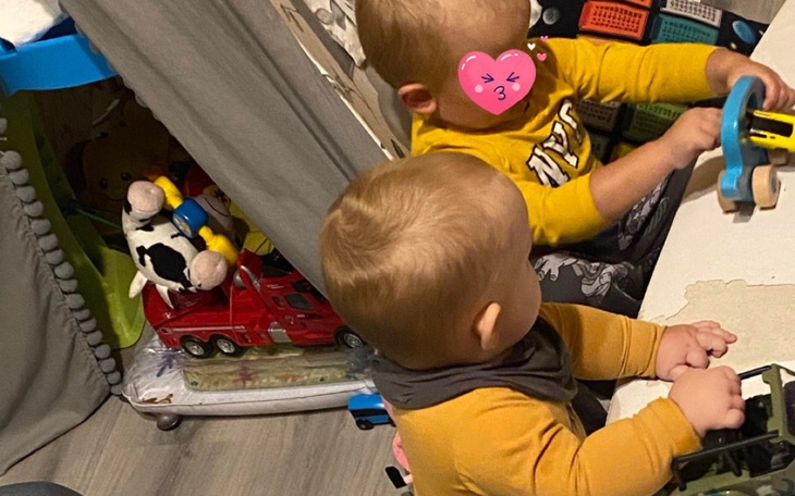 Dwoje małych dzieci bawiących się zabawkami.