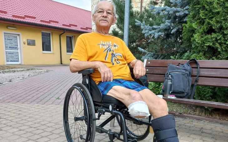 Słodki szczeniak bawiący się na trawie, z zabawką w pysku.