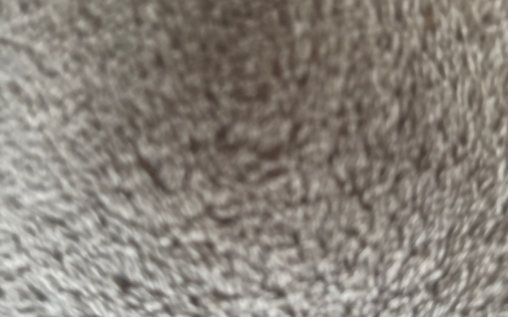 Rozmyty obraz, prawdopodobnie przedstawiający teksturę lub materiał.