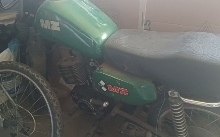 Zielony motocykl MZ w warsztacie, w otoczeniu narzędzi.