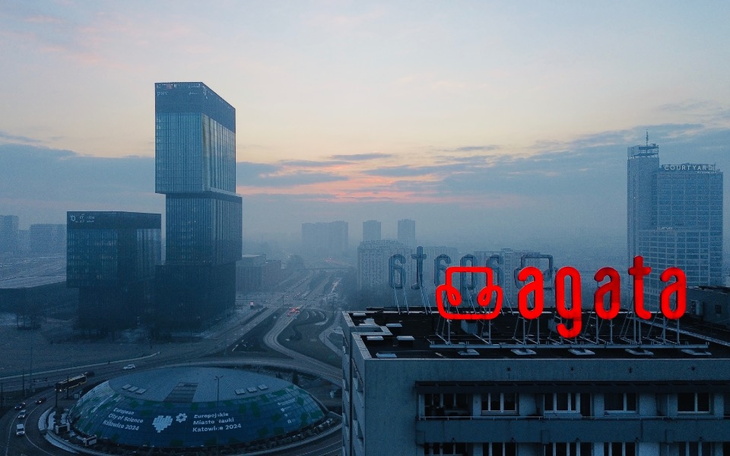 Widok na miasto z wieżowcami w tle, w porannym świetle.