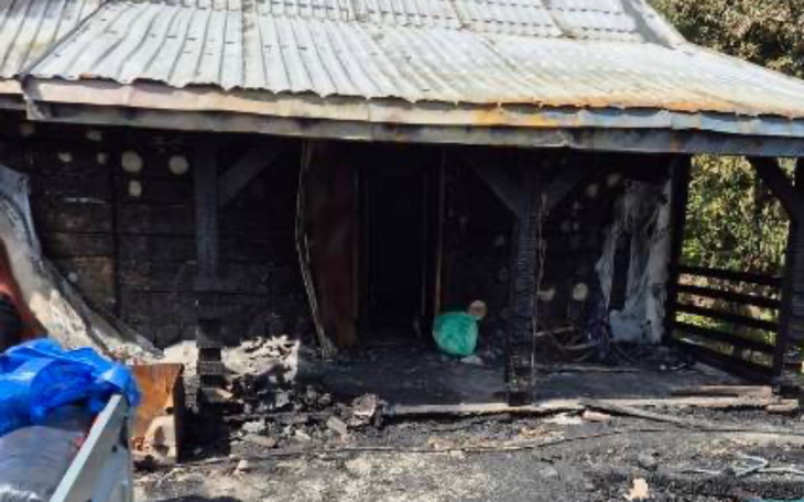 Zniszczony dom po pożarze, z widocznymi uszkodzeniami.