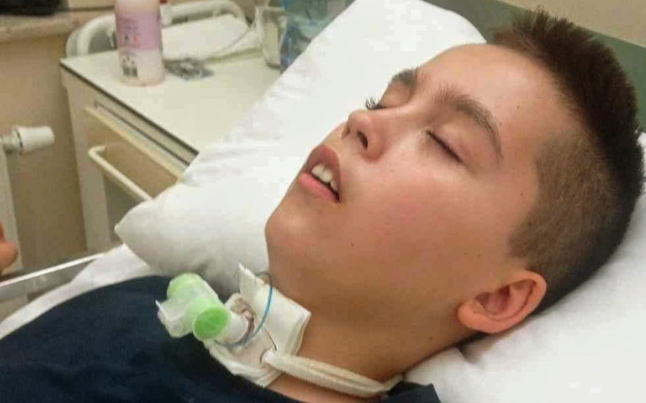 Chłopiec leżący w szpitalnym łóżku.