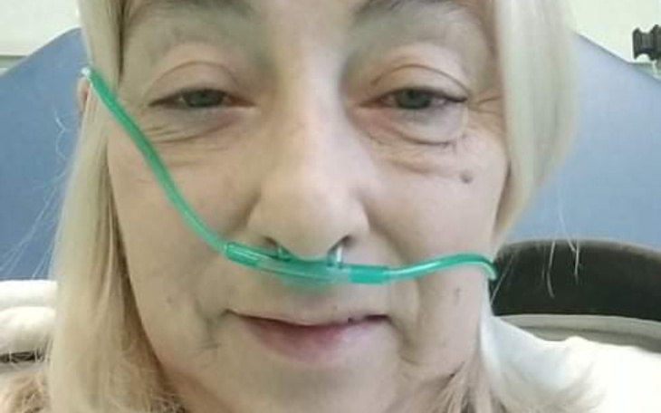 Kobieta w szpitalu z tlenem, pokazująca determinację.